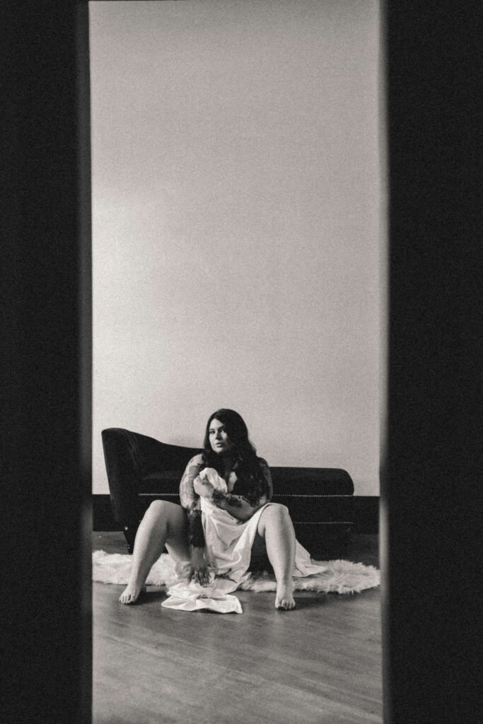 Woman embracing her authentic self during a luxury boudoir photography session