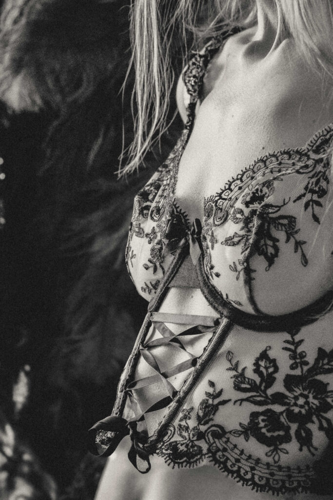Woman embracing her authentic self during a luxury boudoir photography session.