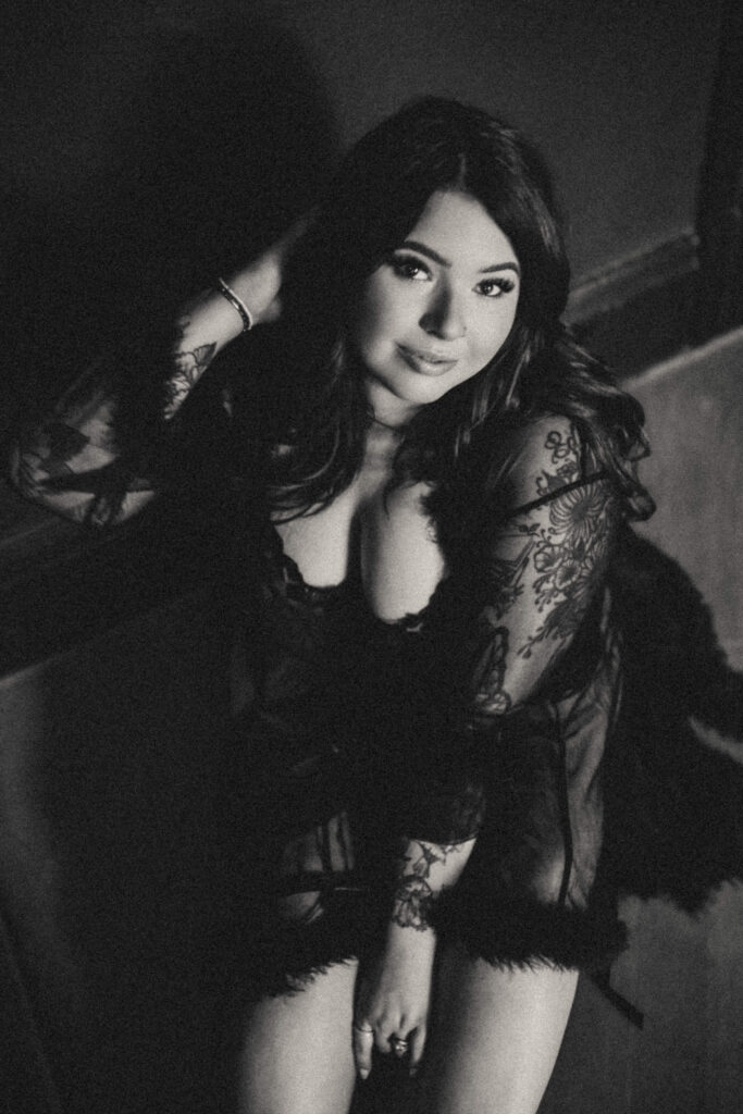 Editorial boudoir portrait of woman sitting on the floor.