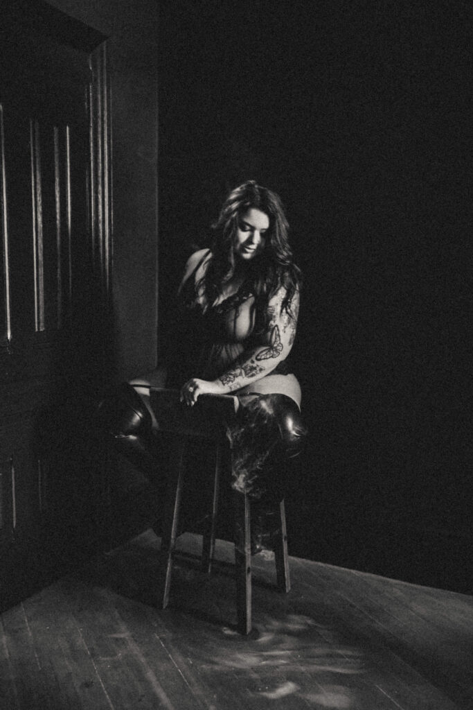Woman embracing her authentic self during a luxury boudoir photography session