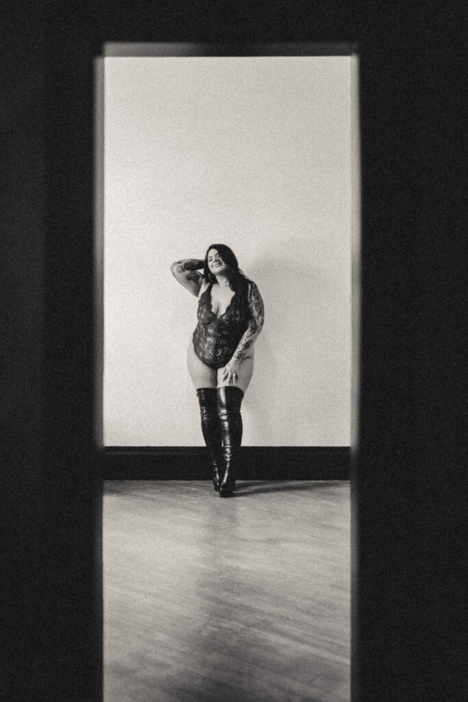 Elegant black and white editorial portrait with dramatic lighting and natural expression