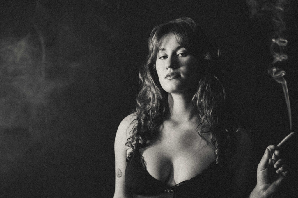 Retro boudoir portrait with vintage fashion and soft haze in a luxury studio.