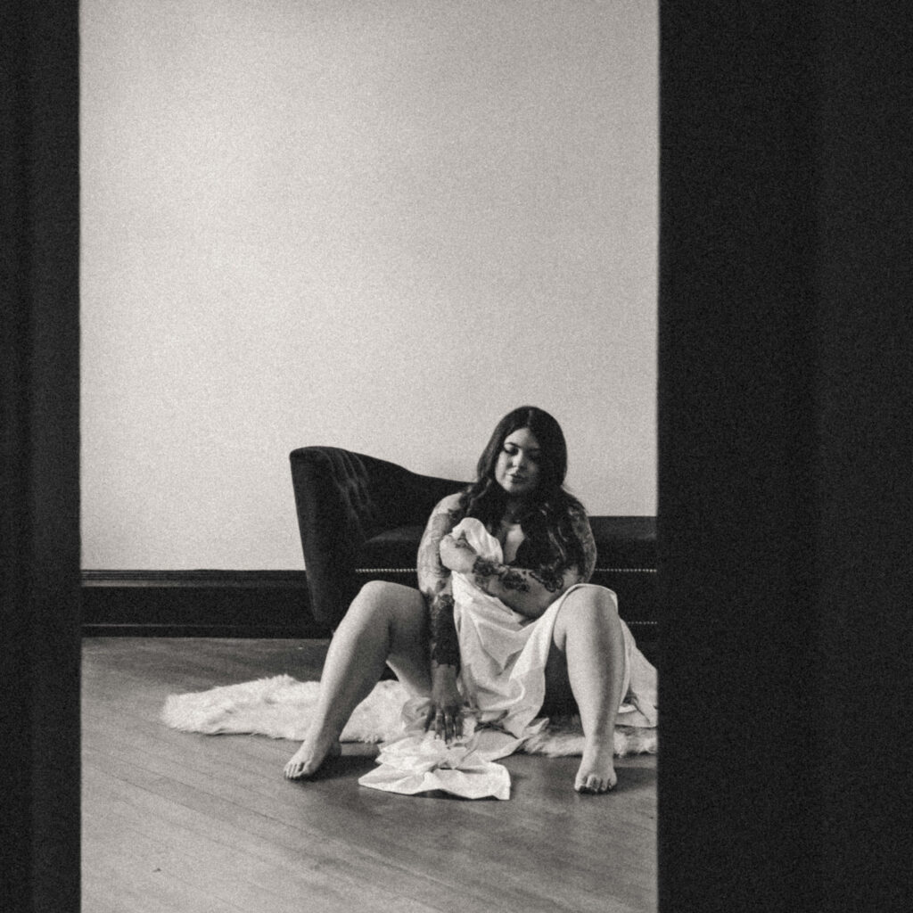 Luxury boudoir portrait celebrating authentic confidence and self-acceptance