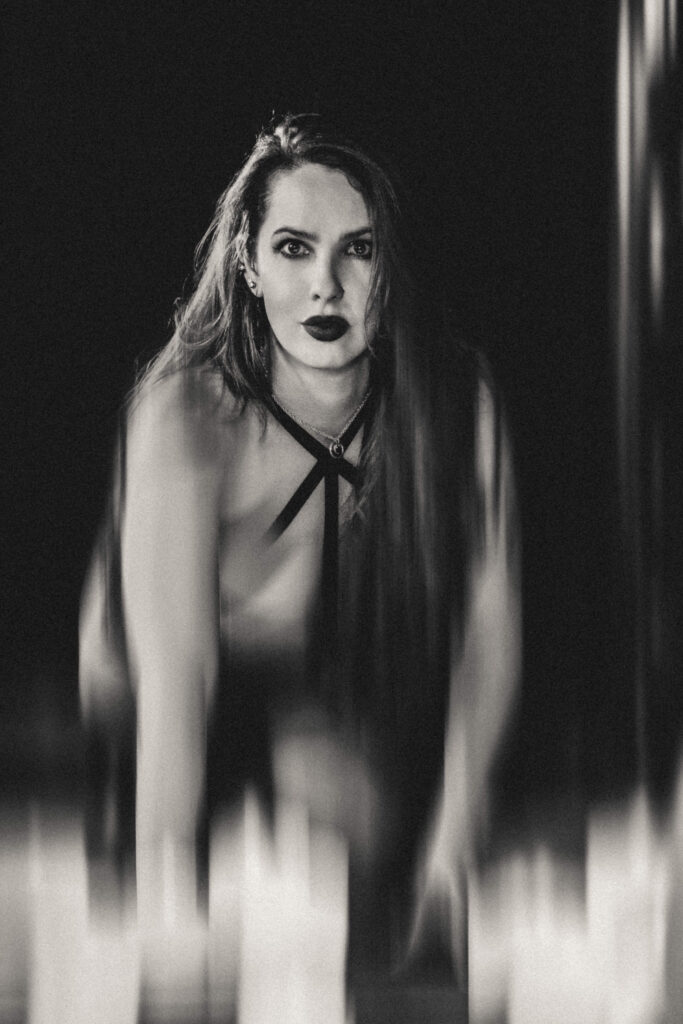 Editorial vampire portrait with moody lighting and cinematic styling in a luxury studio.