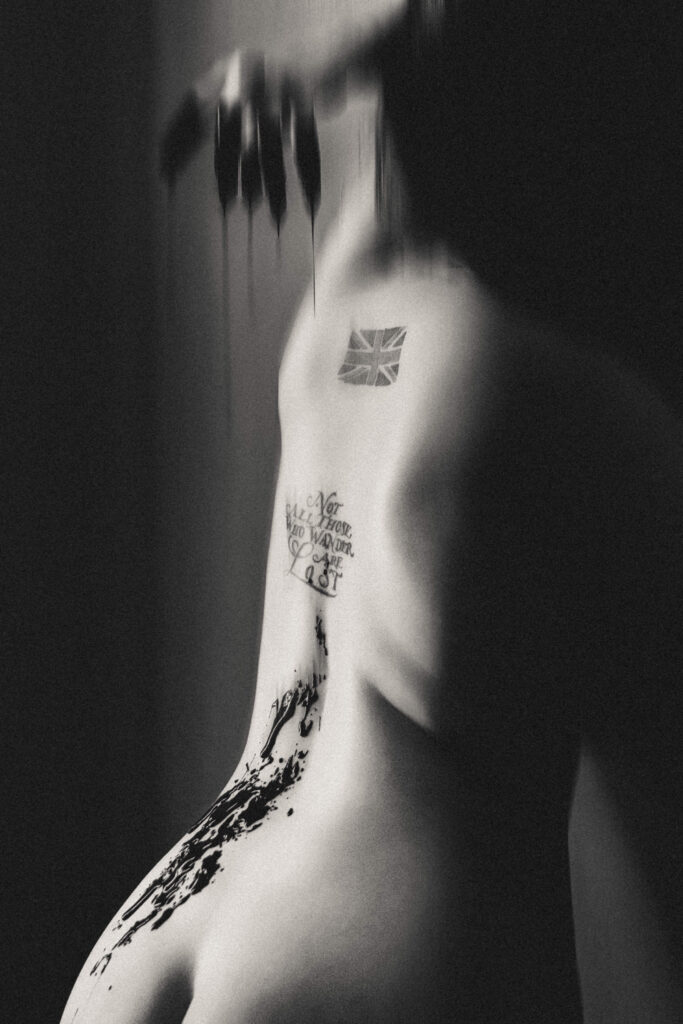 Fantasy boudoir portrait featuring elegant vampire styling and dramatic editorial lighting