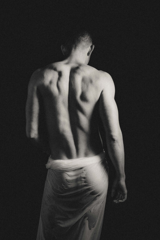 Male boudoir portrait in editorial studio lighting.