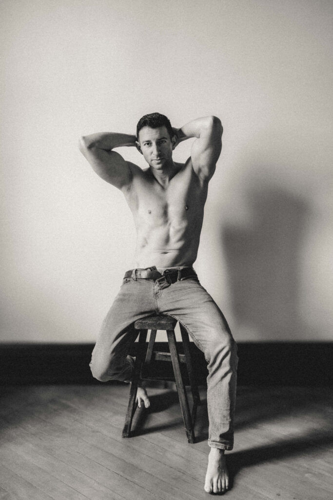 Male boudoir portrait in editorial studio lighting.